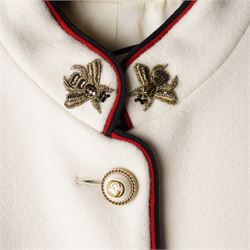 Gucci - bee embroidered wool single-breasted military coat, from the Autumn/Winter 2017 collection under Alessandro Michele, in ivory, with stand collar, red and navy trim, pearlescent and gold-tone button fastening and embroidered bee detailing to the collar, size 14, unused with original garment bag and tags