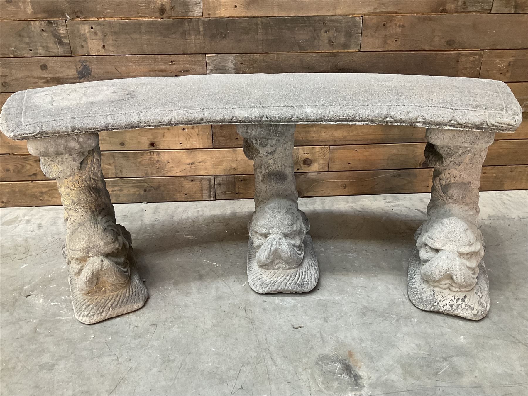 Cast stone four piece curved Dolphin bench, set with three dolphin pillars, curved rectangular slab top with detailed border