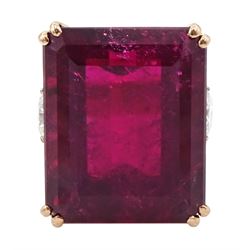 Rose gold rubellite tourmaline and diamond ring, the central octagonal step cut tourmaline of 43.25 carat, with a round brilliant cut diamond set either side and diamond set shoulders by Judith Crowe, hallmarked 9ct, the two large side diamonds total 2.10 carat, with World Gemological Institute report