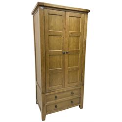Oak double wardrobe, fitted with panelled doors enclosing hanging rail, fitted with two drawers to the base