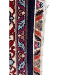 Persian Hamadan indigo ground rug, central floral crimson pole medallion surrounded by trailing foliate decoration and stylised plant motifs, the main guarded border with repeating stylised flower heads, densely knotted