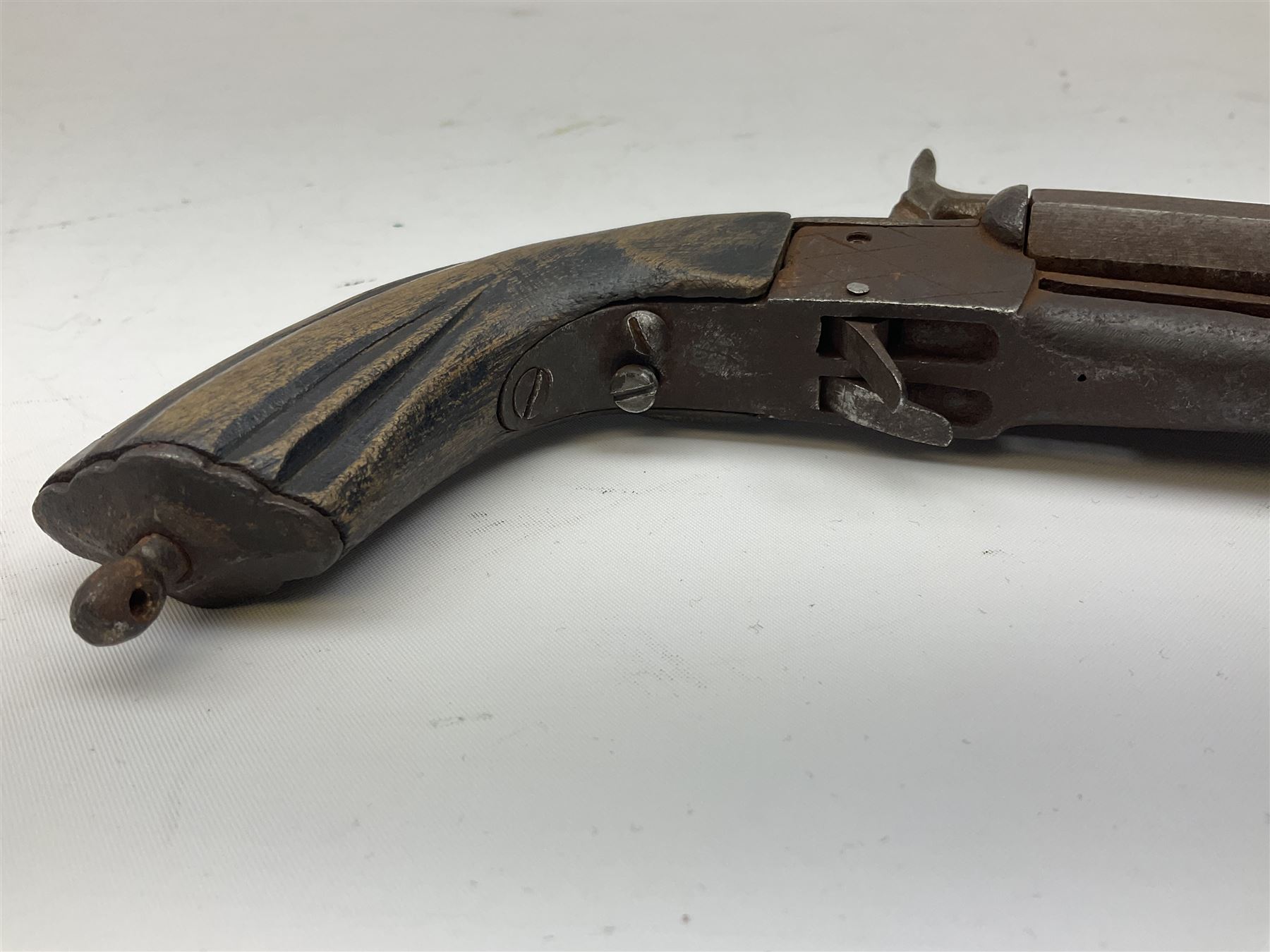 19th century Belgian 9mm side-by-side double barrel pin-fire pocket pistol with 11cm octagonal single block barrel, drop-down triggers and carved walnut stock L22.5cm overall