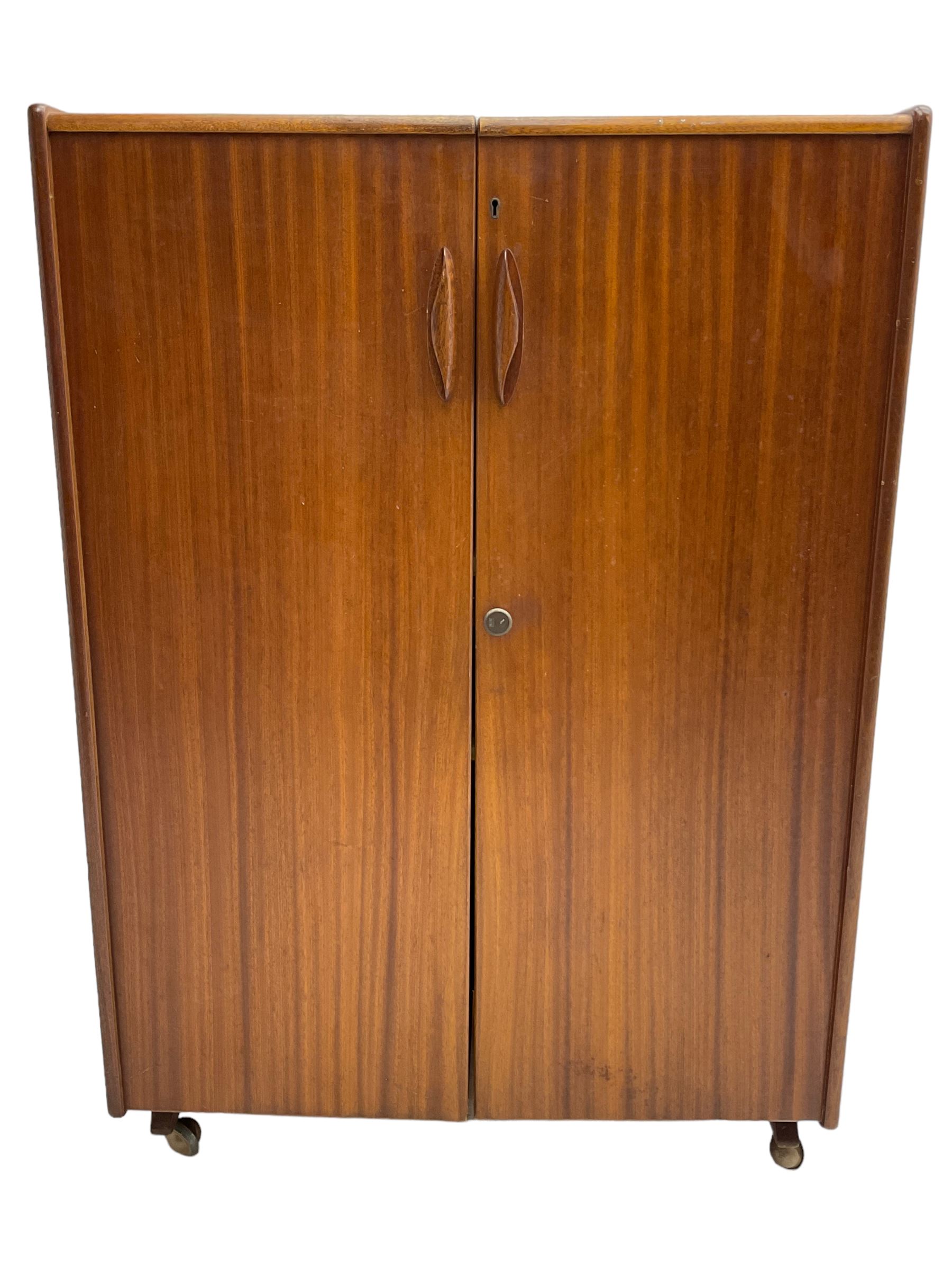 Mummenthaler & Meier - mid-20th century circa. 1960s teak 'Magic Box' folding desk cabinet, the cabinet opens to reveal shelves, writing desk, document holders and lamp, on castors