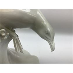 1930s Meissen figure of a seagull designed by Max Esser, modelled upon the crest of a wave with wings spread above its body, upon black square base, with blue cross swords mark, H43cm
