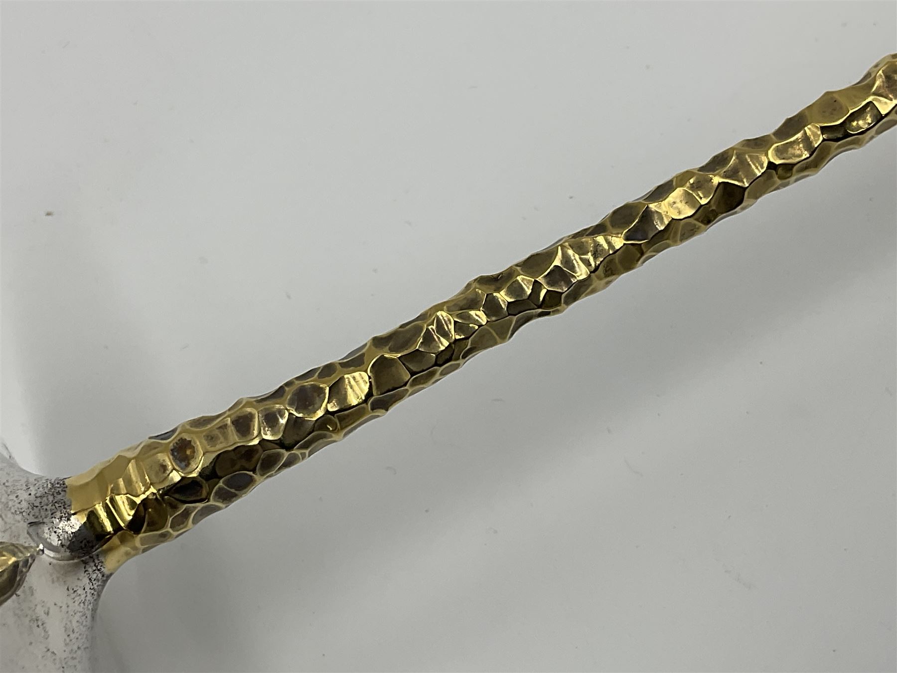 Pair of modern silver candlesticks by Stuart Devlin, the tapering parcel gilt stems with signature textured detailing, each supporting a fluted candle holder and upon a spreading circular foot, hallmarked Stuart Devlin, London 1973, H25cm