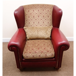  Wingback armchair upholstered in a maroon leather and light gold patterned fabric, turned supports, W96cm  