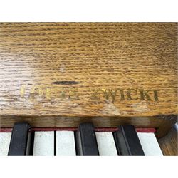Louis Zwicki - mid-20th century oak cased compact piano, fitted with a folding music rest and full keyboard, dual brass pedals