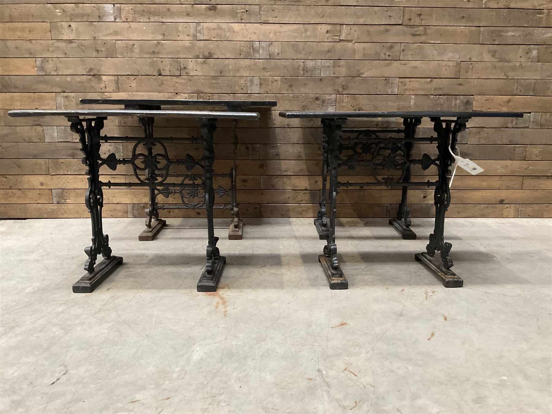 Four cast iron pub or bar tables with rectangular tops