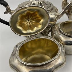 Five piece Edwardian silver tea service, comprising teapot and coffee pot, each with ebonised scroll handle, tea caddy with hinged cover, twin handled open sucrier, and milk jug, each of rounded bombe form, upon four paw feet, hallmarked William Adams Ltd, Birmingham 1904 and 1905, coffee pot H26cm
