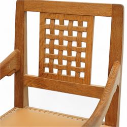 Mouseman - set of six oak dining chairs (5 + 1), pierced and carved lattice back over leather upholstered seat, on octagonal front supports united by stretchers, carved with mouse signature, by the workshop of Robert Thompson, Kilburn