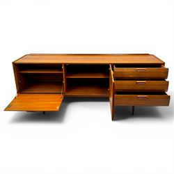 BCM (Bath Cabinet Makers) - mid-20th century teak sideboard, rectangular top with back gallery, left hand side fall front cupboard, centre cupboard opening to reveal a shelved interior, the right side with a bank of three drawers one fitted for cutlery, raised on inset tapering supports
