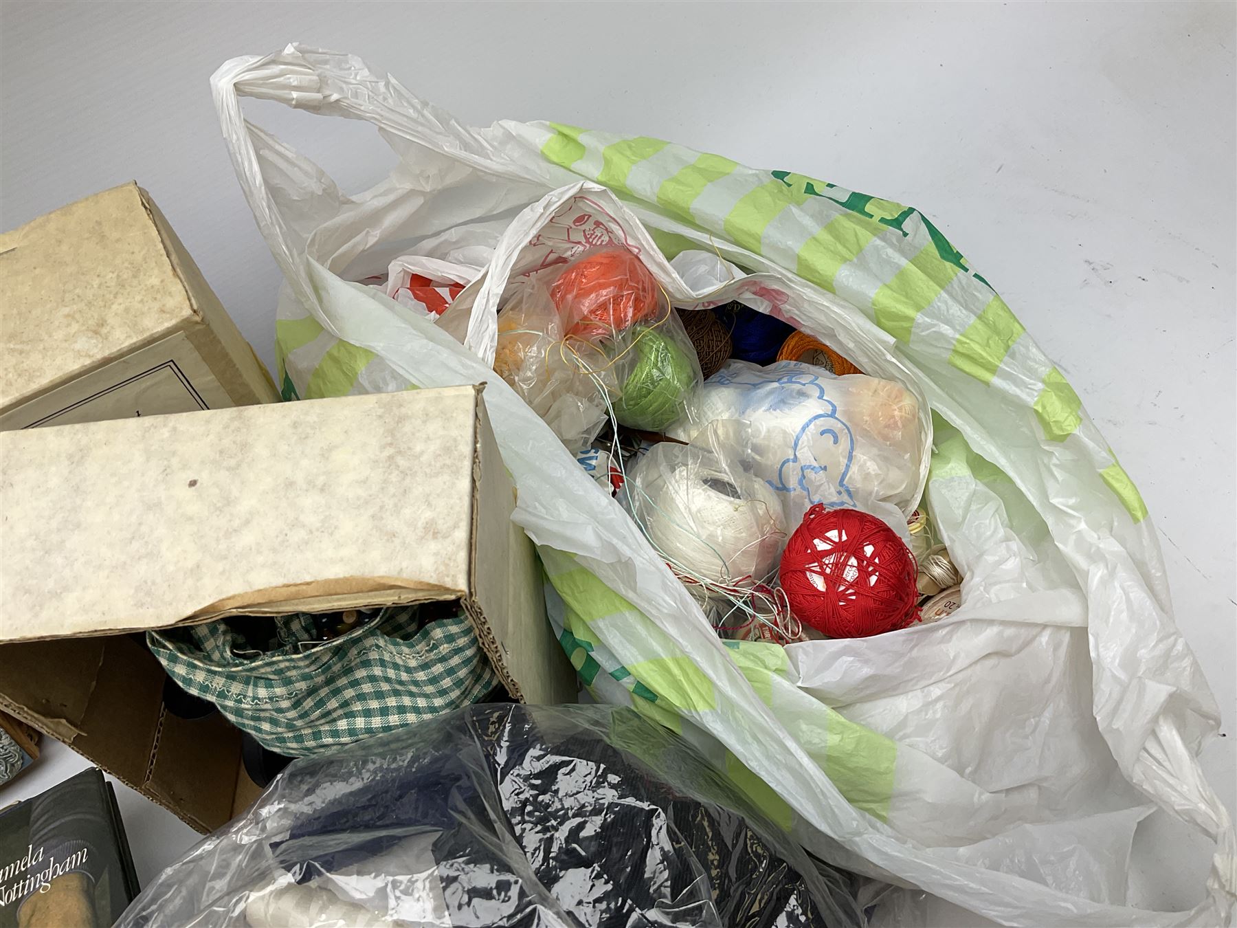 A quantity of lace making equipment, to include pillows, wooden bobbins, boxed bobbin winder, books, etc. 