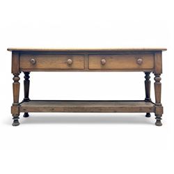 Late 19th century oak potboard dresser base, rectangular top over two frieze drawers with turned wooden handles, raised on four ring turned and tapering supports with block feet, united by a full-width lower potboard
