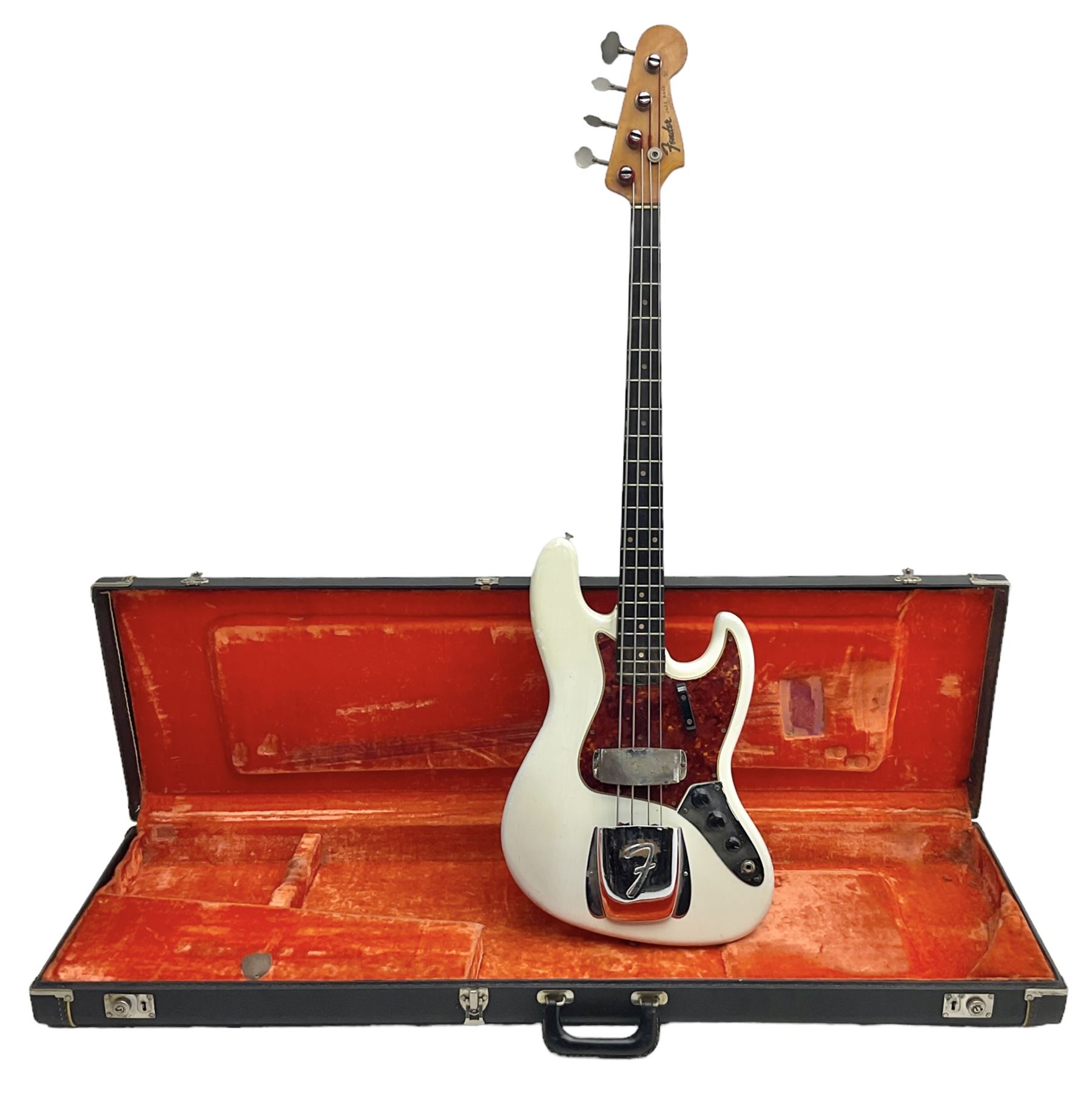 1963 Fender Jazz three-knob bass guitar; impressed with date code 7AUG63A on end of neck and serial no.L08587 on back plate; all original but re-finished in white in the 1970s; sold with photographs of the instrument in the 1960s with original finish and in the 1970s re-finished; L117.5cm; in original hard carrying case; Provenance: the professional guitar of Howard Livett from new to his death in 2005. Howard played in The Humperdincks, the backing group for Englebert Humperdinck, also played in the backing group for Max Bygraves and in the band Hedgehoppers Anonymous. The guitar is also sold with a manuscript letter of provenance from Howard's wife.