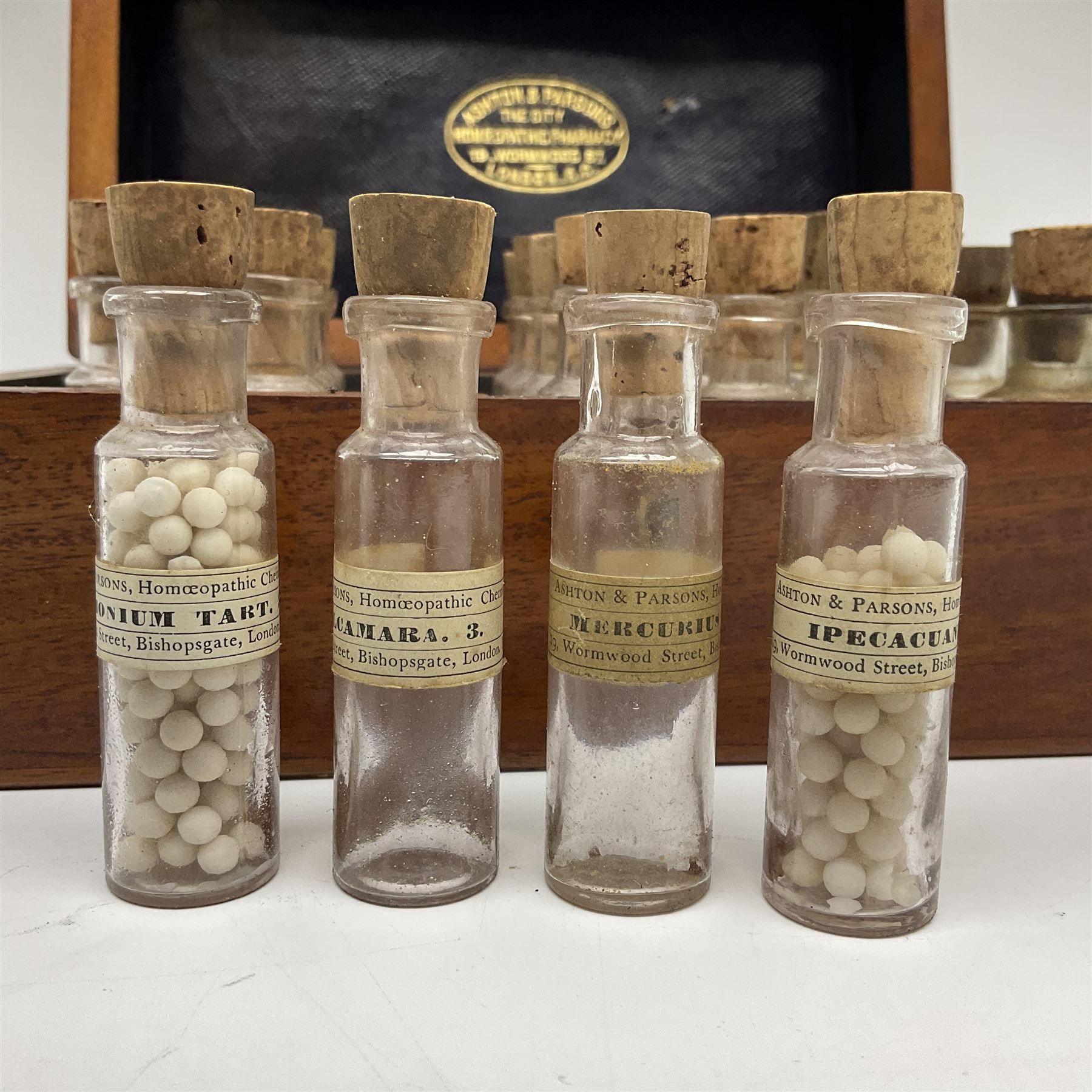Ashton & Parsons Homeopathic pharmacy box, the fitted interior with thirty glass bottles with cork stoppers and labels to the glass, H10cm, L21cm