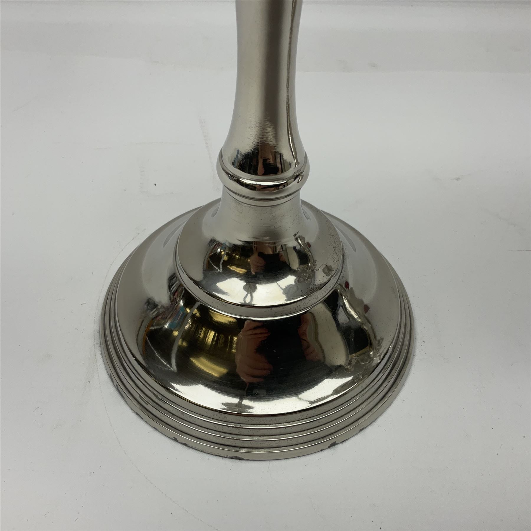 Pair of four branch candelabras, urn-shaped nozzles raised upon scroll branches supported from tapering central stem, with a stepped circular base, H40cm