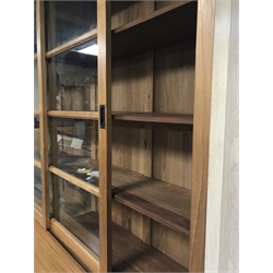  Large solid teak bookcase cabinet, top section enclosed by two glazed sliding doors, bottom section enclosed by two panelled sliding doors, fitted with twelve shelves, W200cm, H221cm, D48cm  