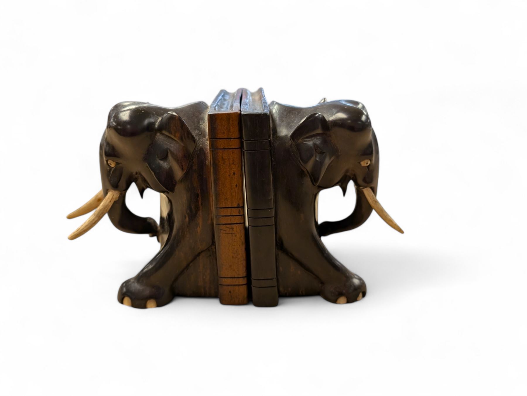 Pair of carved elephant bookends with bone tusks, H14.5cm