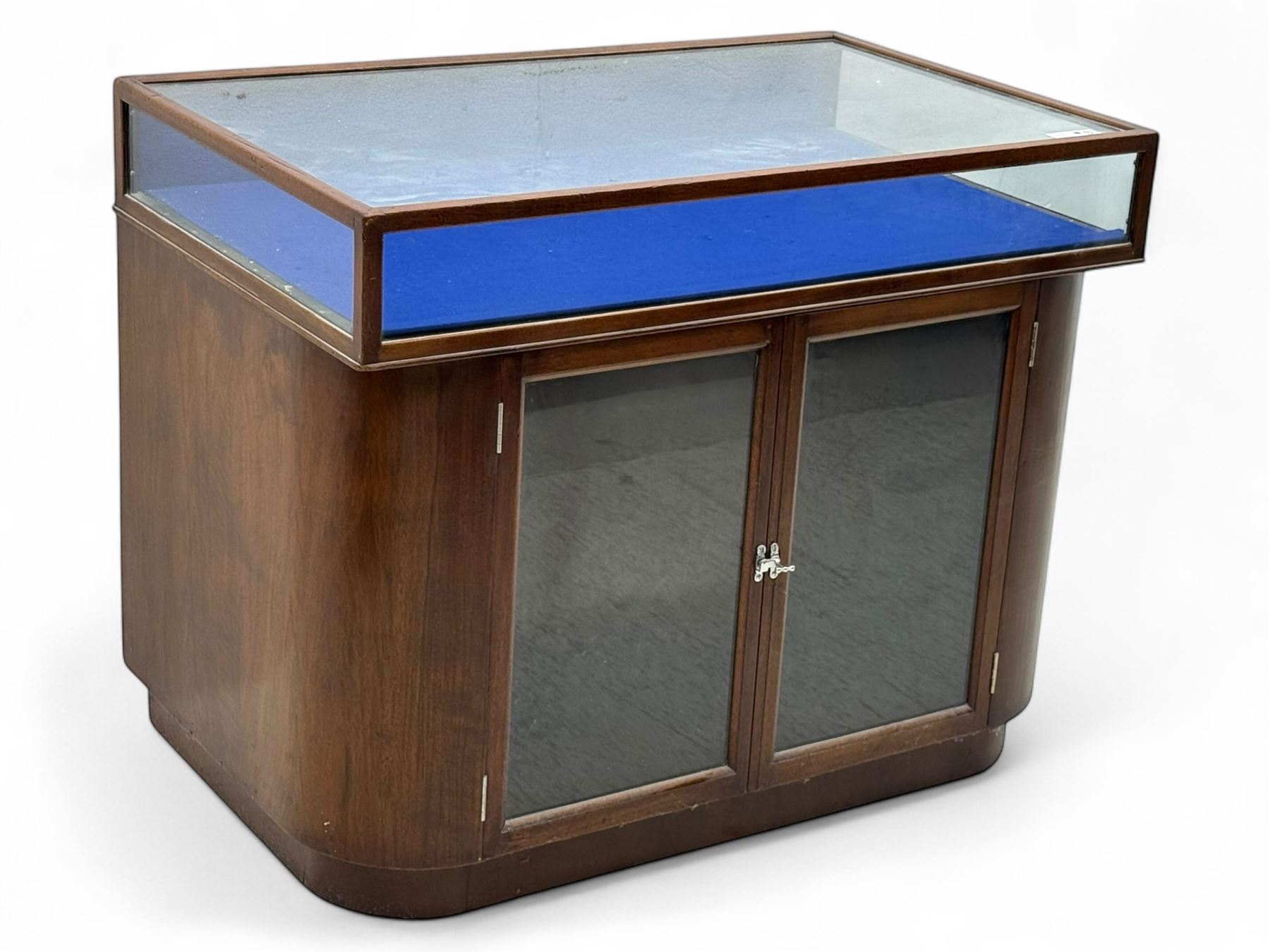 Edwardian inlaid mahogany display cabinet fitted with two glazed cupboards, fitted with rectangular glazed top and sides over a blue velvet interior, twin glazed doors below enclosing a shelved interior on a curved plinth