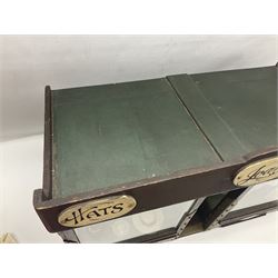 Early 20th century scratch-built wooden hat & gown shop diorama 'Joan', of double-fronted form glazed on three sides with brass and aluminium mounts, rear access apertures and storage under L63cm H45cm D31cm; with small collection of dresses and hats on display stands