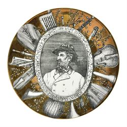 Fornasetti Grandi Maestri plate, depicting Giuseppe Verdi within a border of operatic emblems on gilt ground, with printed mark beneath, D25cm