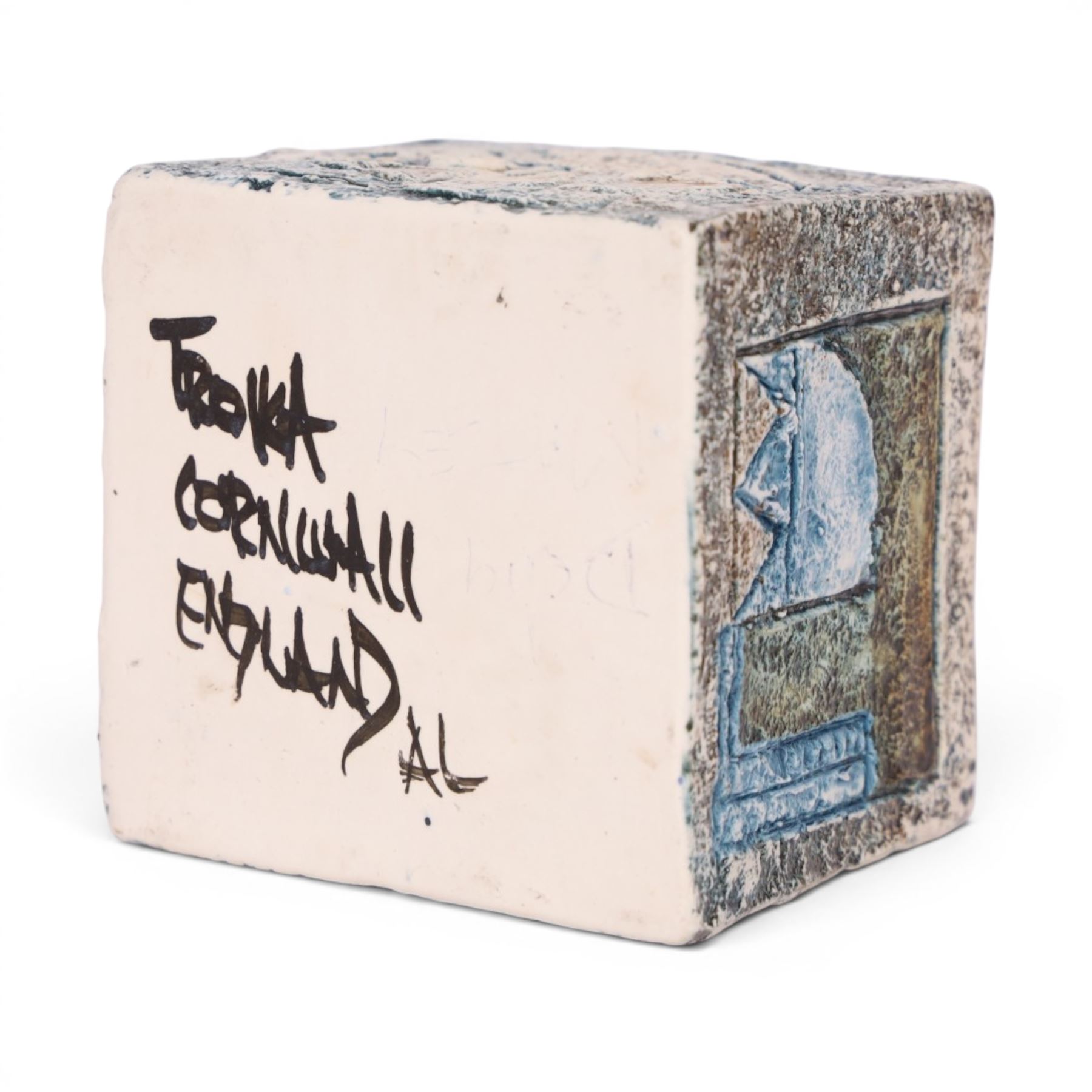 Troika cube vase by Anne Lewis, with geometric incised decoration in blue on a mottled blue ground, signed to base with initials