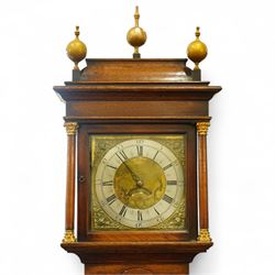 Gilbert Kidd of Malton-oak cased mid-18th century 30hr longcase clock, with a caddy top and three gesso finials, square hood door flanked by turned pilasters with Corinthian capitals, trunk with a long wavy topped door on a square plinth with an shaped skirt, brass dial with an engraved dial centre, date aperture and steal hands, silvered chapter ring with Roman numerals and five minute Arabic's, dial pinned to a chain driven countwheel striking movement. With a brass cased weight and pendulum. 