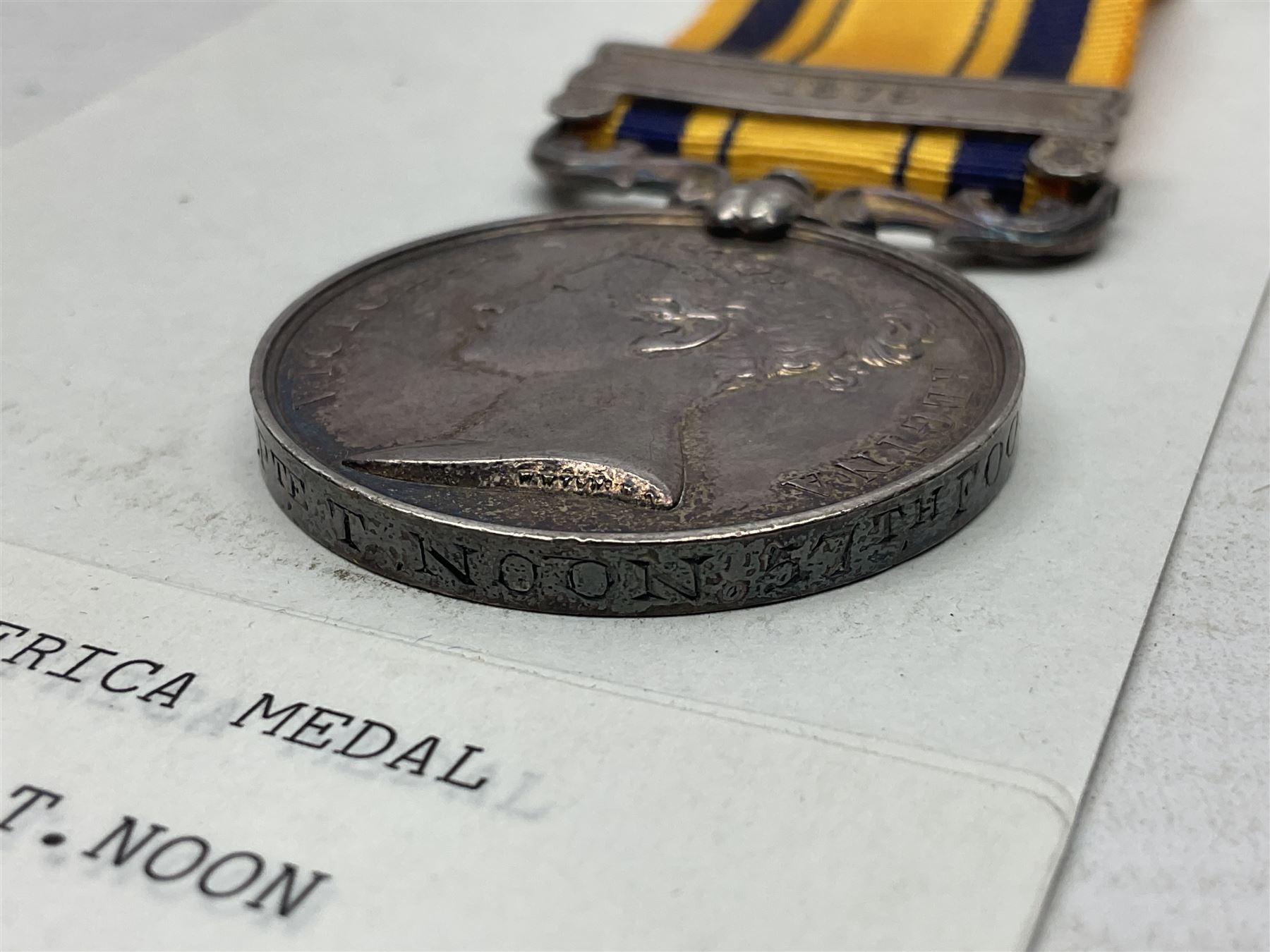 Victoria South Africa Medal (Zulu Wars) 1877-79 with 1879 clasp awarded to 50/544 Pte. T. Noon 57th Foot (West Middlesex regiment); with replacement ribbon but original ribbon present