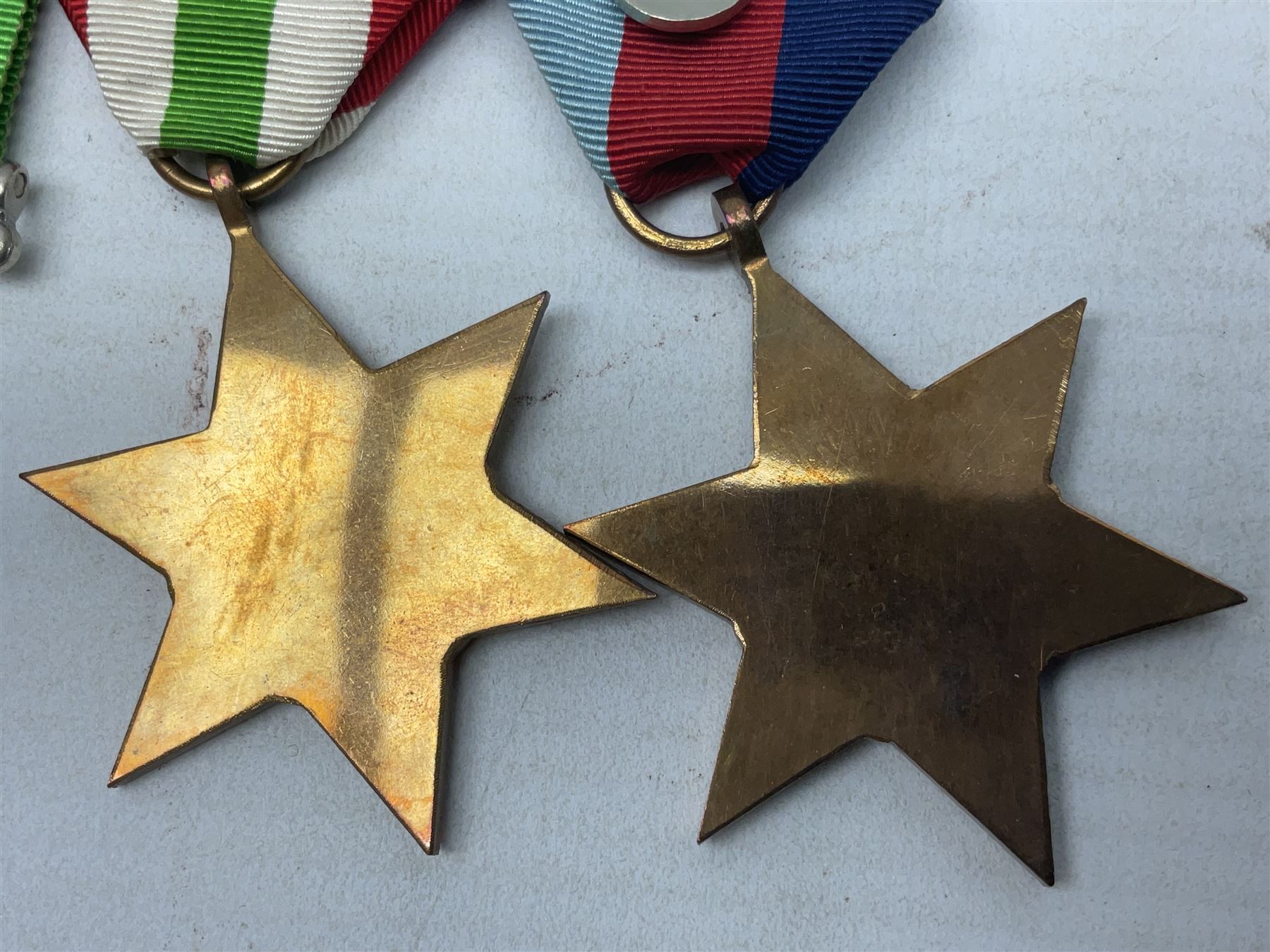 WW2 group of four medals comprising 1939-1945 War Medal, Defence Medal, Italy Star and 1939-1945 Star; with Royal Army Service Corps cap badge and RASC chrome and enamel sweetheart brooch