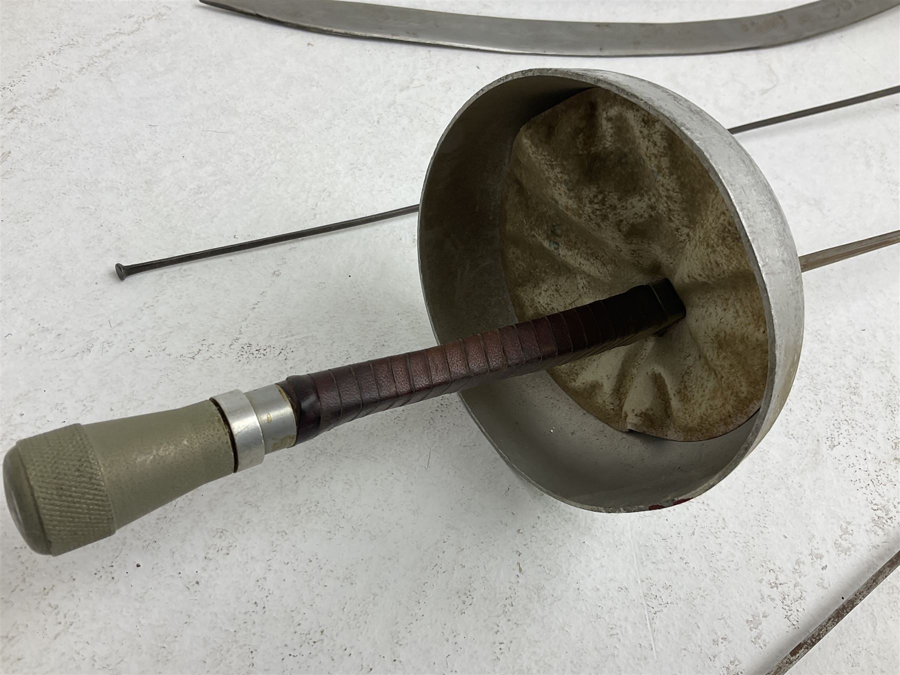 20th century Indian Tulwar sword with 71cm plain curving steel blade and iron hilt with extended langets, knopped grip and spiked pommel; in canvas covered wooden scabbard L87.5cm overall; together with five fencing swords comprising four foils and one epee, three marked Leon Paul, one in carrying case (6)