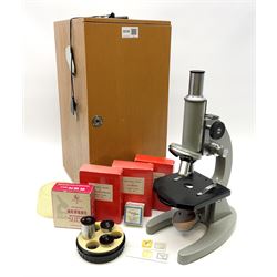 Chinese grey painted monocular microscope possibly by the Wu Chow Optical Instrument Company, with rack and pinion focusing H33cm in fitted wooden case with additional lenses: together with three boxes containing thirty-five prepared glass slides entitled Plants, Insects and Structure of Blood