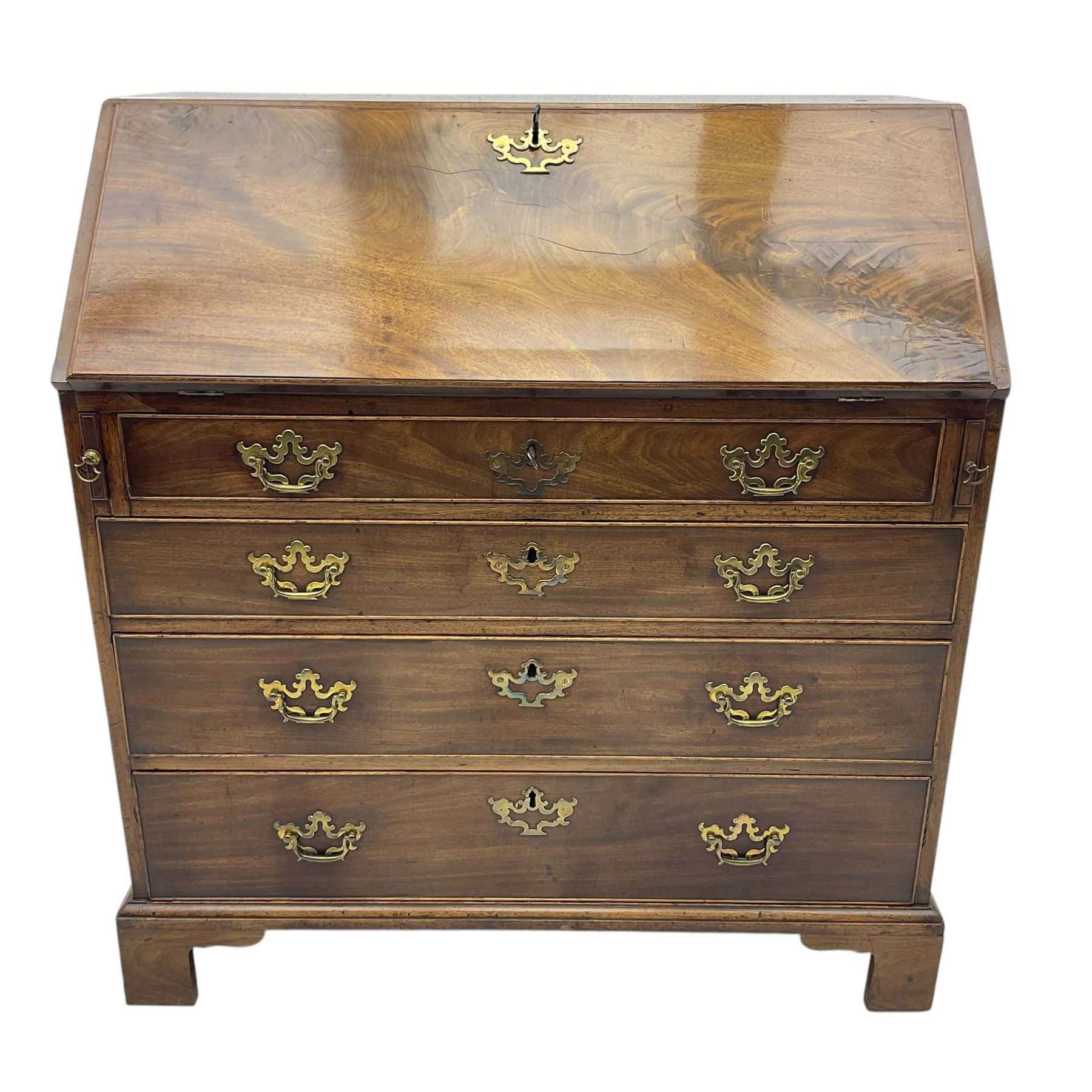 George III mahogany bureau, fall-front enclosing a fitted interior of drawers, pigeonholes and central mirrored cupboard, over four graduated cockbeaded drawers with brass batwing handles, raised on bracket feet