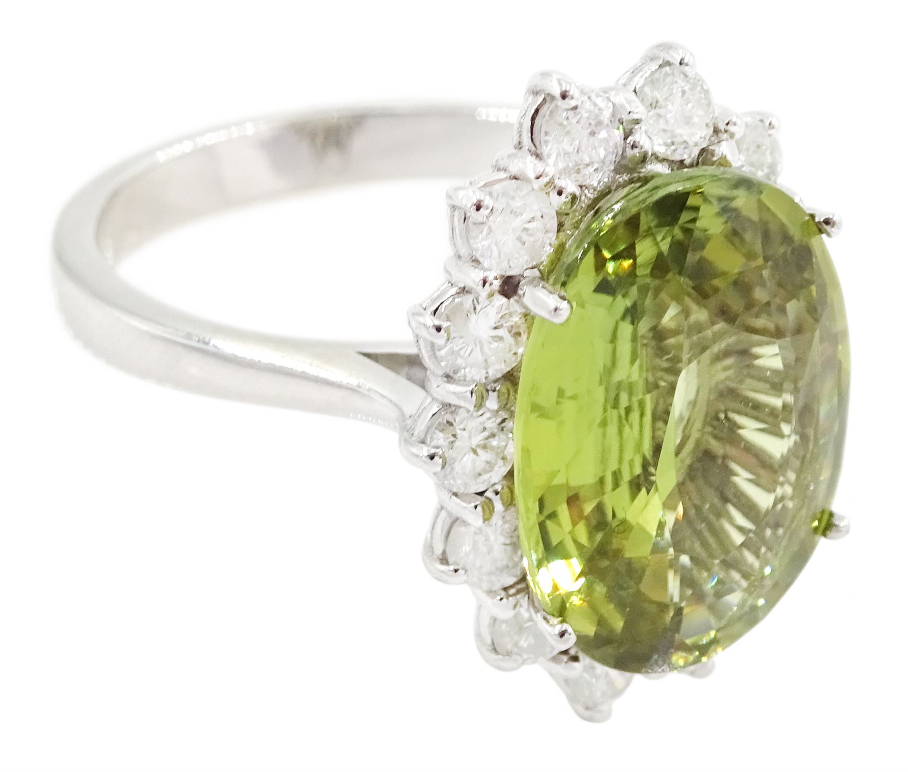 18ct white gold alexandrite and diamond cluster ring, the natural oval cut green alexandrite of approx 5.95 carat, surrounded by fourteen round brilliant cut diamonds, stamped 750, total diamond weight approx 0.80 carat
