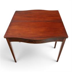 Regency period inlaid mahogany serpentine-fronted fold-over tea table, the shaped rectangular top with ebony-strung edge over a banded frieze with repeating lozenge inlaid banding, on square tapering supports