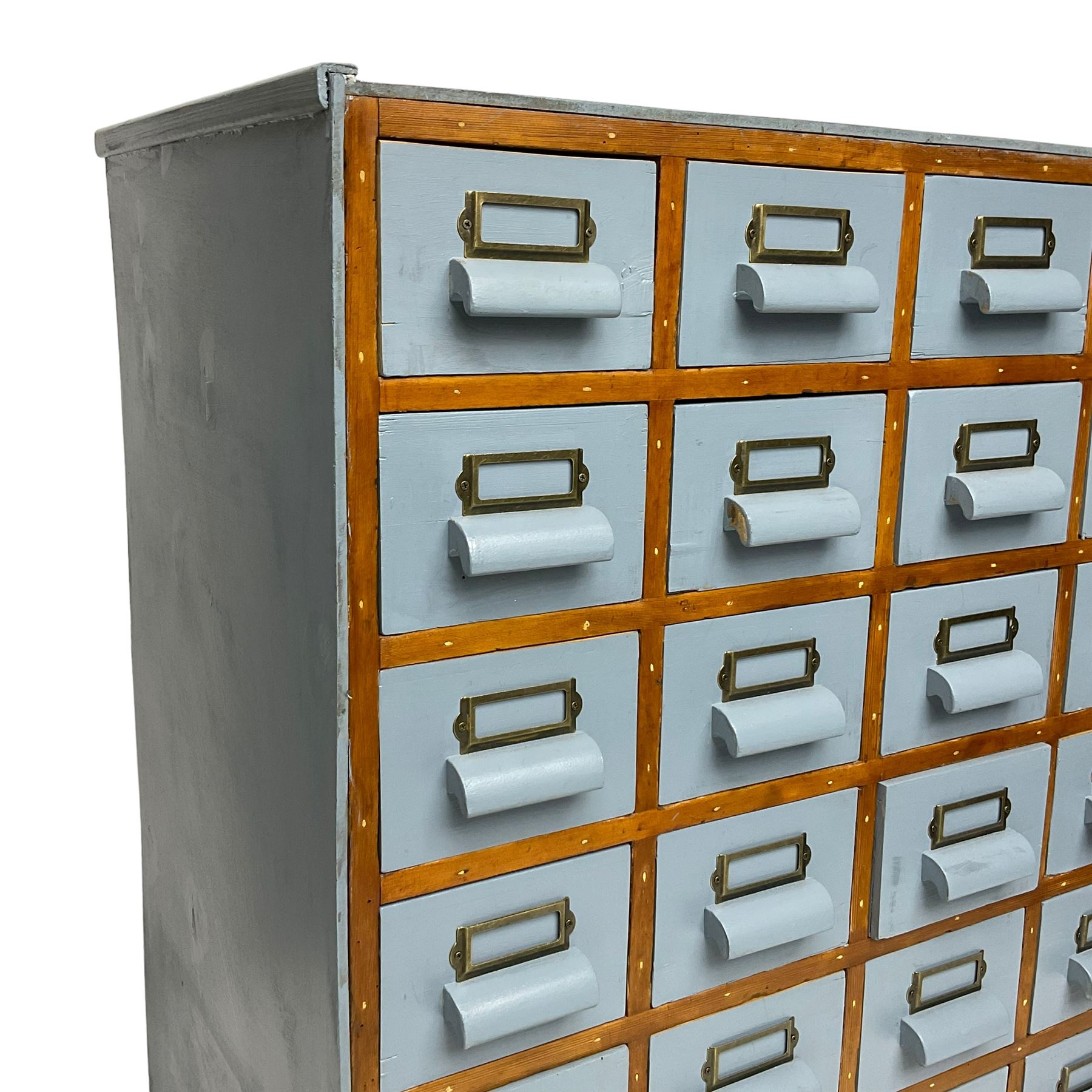 Mid-20th century multi-drawer chest or filing cabinet, fitted with thirty-five small drawers with wooden handles and metal label holders, in light blue paint finish 