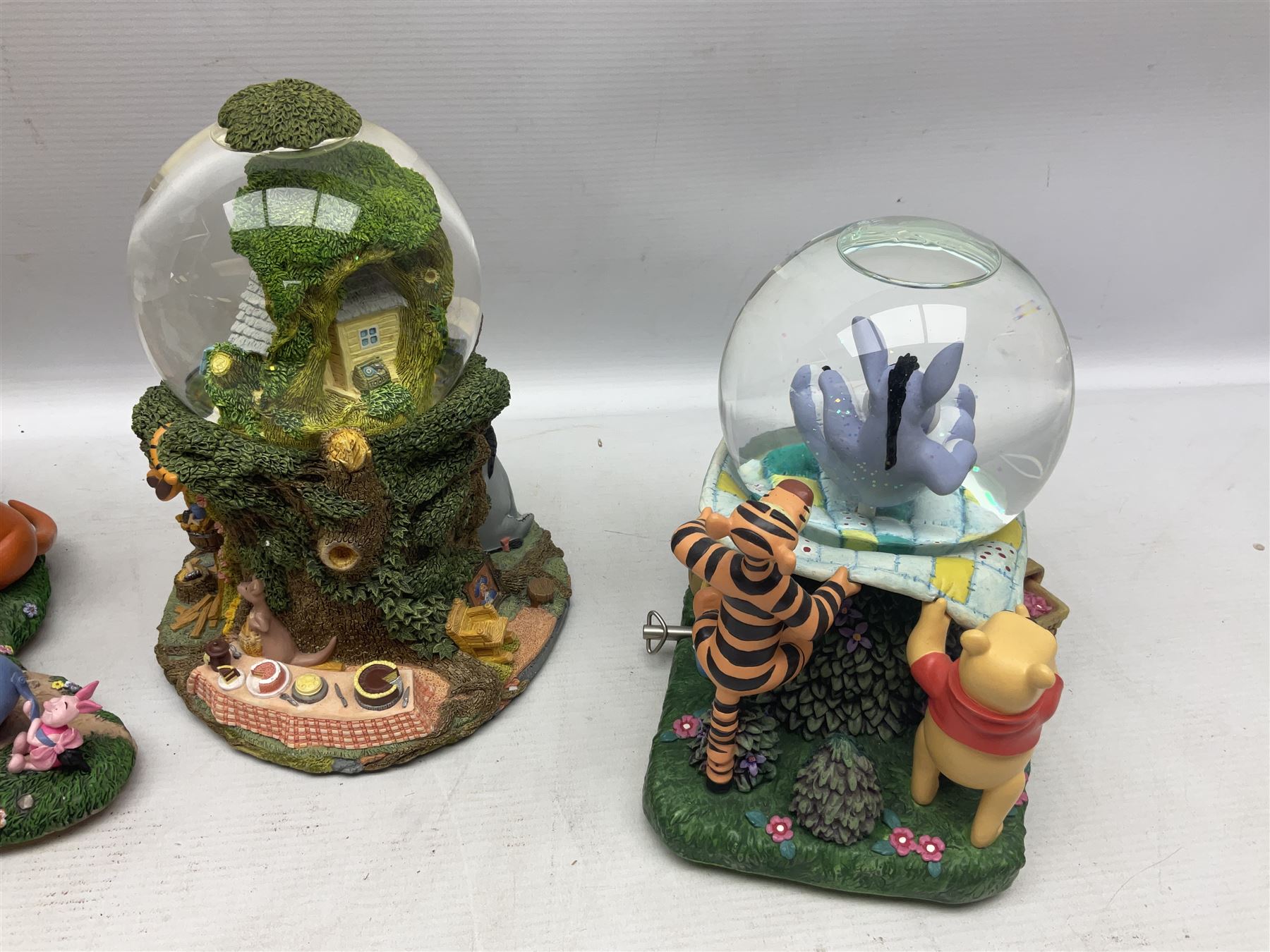 Five Disney Winnie The Pooh snow globes to include The Rain Rain Rain Came Down Down Down, Eeyore Pulling Cart, Owl's House, Rumbly in My Tumbly and Stuck In Rabbit's House, together with figure group with dome, five with boxes (6)