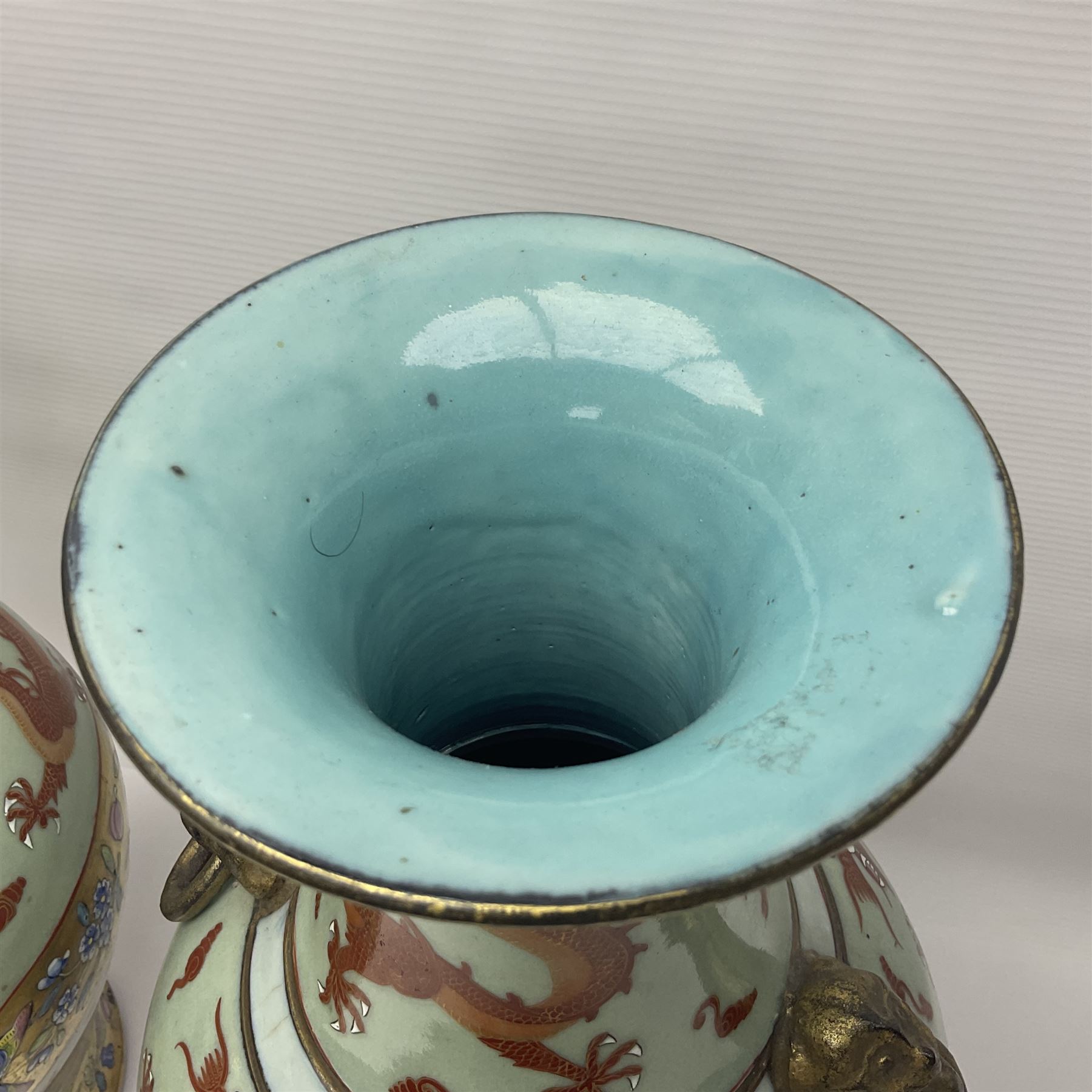 Pair of early 20th century Chinese vases decorated with dragons chasing a flaming pearl, with a gilt border of butterflies and floral sprigs, with Elephant head handles, H44cm 