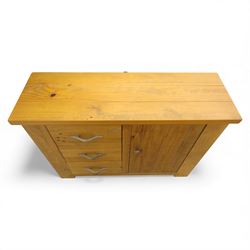 Contemporary pine side cabinet, rectangular top with moulded edge, fitted with three drawers with brushed metal handles alongside a single cupboard door with round metal knob, plain sides, raised on square block feet