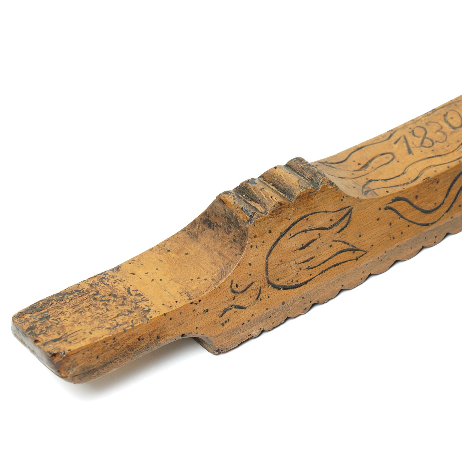 19th century treen mangle board, incised date 1830, decorated with various foliage, W70cm 