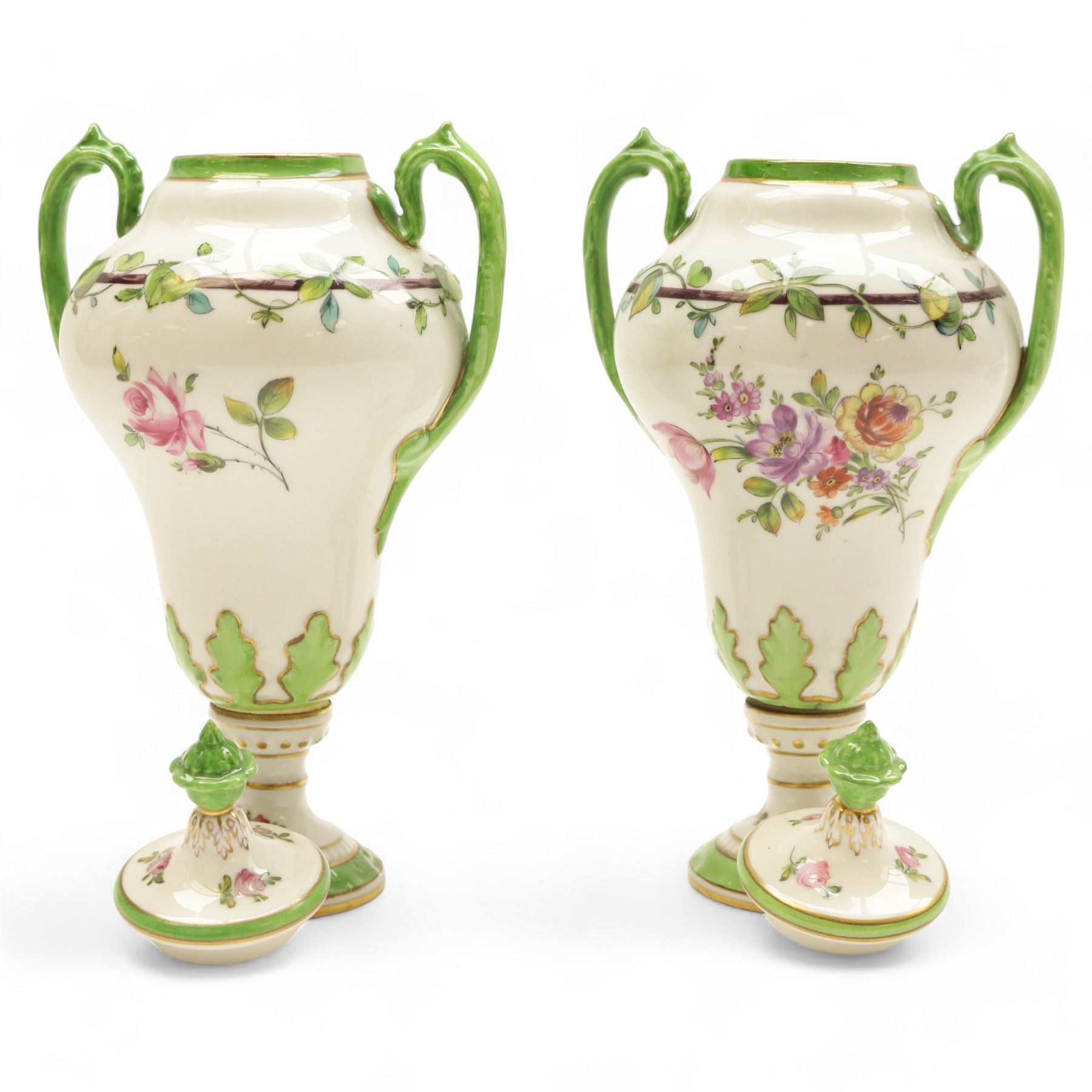 Pair of Dresden lidded vases with twin handles, decorated with flowering sprigs and a foliate boarder, H25cm