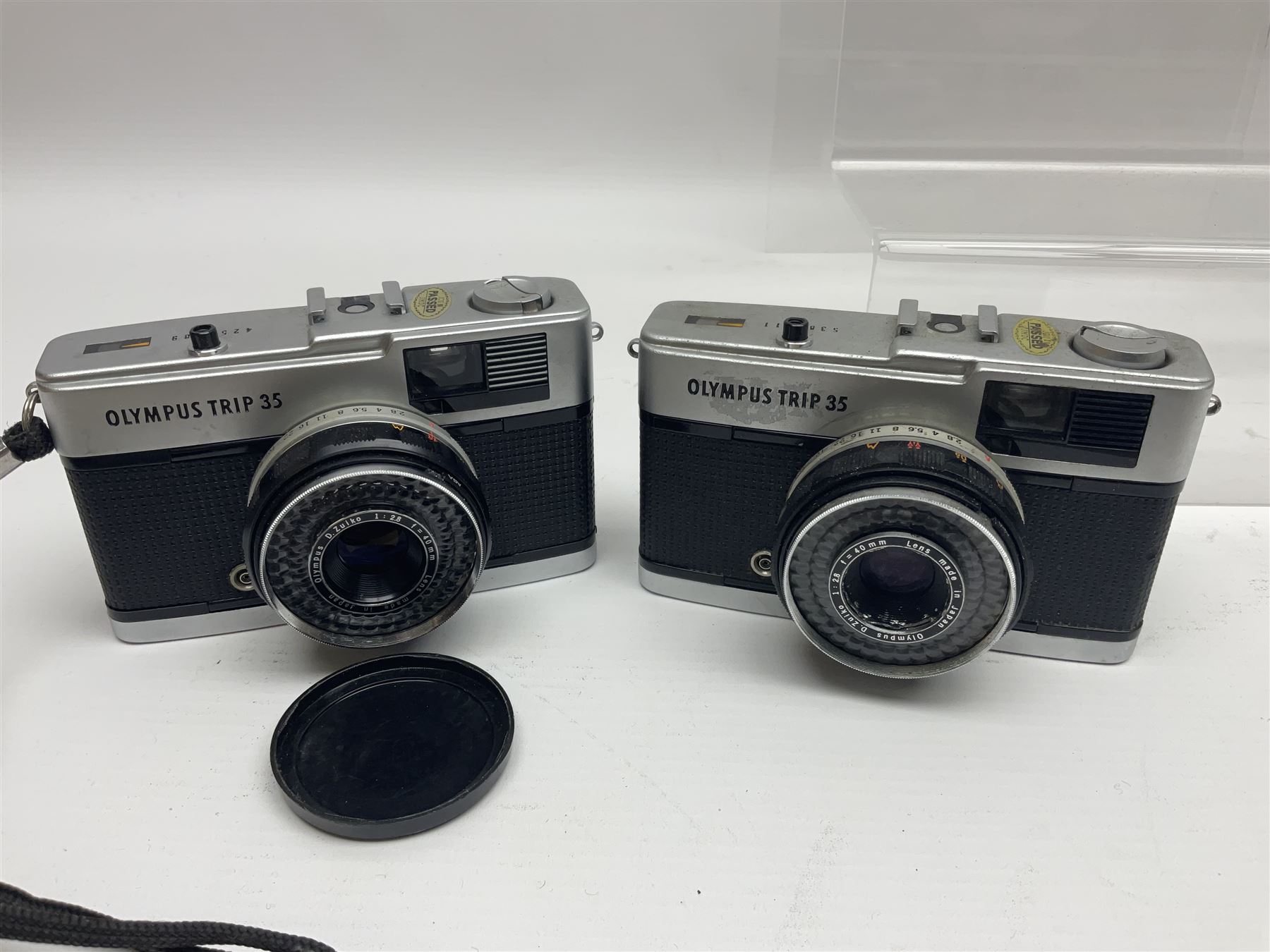 Olympus Pen-EE camera, serial no 415299, with Olympus D.Zuiko 1:3.5 f=2.8cm lens, together with four Olympus Trip 35 cameras, serial nos 4759245, 4257589, 1847727 and 5387611, each with Olympus D. Zuiko 1:28 f=40mm lenses