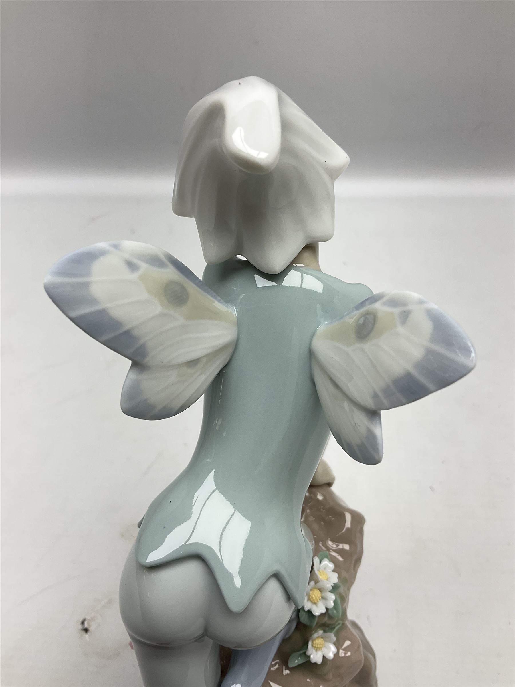 Lladro Privilege figure, Prince of Elves, modelled as an elf with wings leaning upon a rock, with original box, no 7690, sculpted by Joan Coderch, year issue 2001, year retired 2003, H23cm