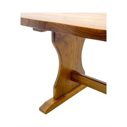 Late 20th century oak trestle table, rectangular top with naturalistic edge, supported by two curved pedestal bases united by central stretcher, on block feet