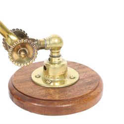 John Dugdill, early 20th century brass angle poise desk lamp, circa 1930's, with daisyhead joints and amber coloured lampshade, upon a circular wooden base 