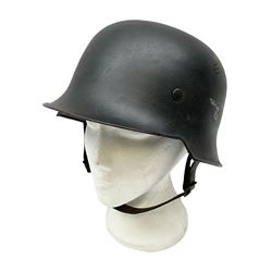 WW2 German steel combat helmet with eagle insignia to one side and U-724 to the other, leather liner marked No.56 and leather chin strap; indistinctly stamped to the skirt '*ahl'
