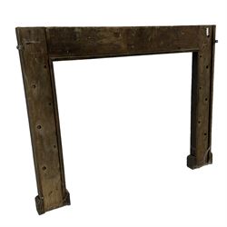 19th century Jacobean Revival oak fire surround, decorated with applied carved panels depicting foliate patterns and stylised grape vines, uprights carved with fleur-de-lis decoration