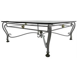 Wrought metal and glass top coffee table, square glass top on scrolled supports with brass feet, scrolled stretchers with pineapple finial 