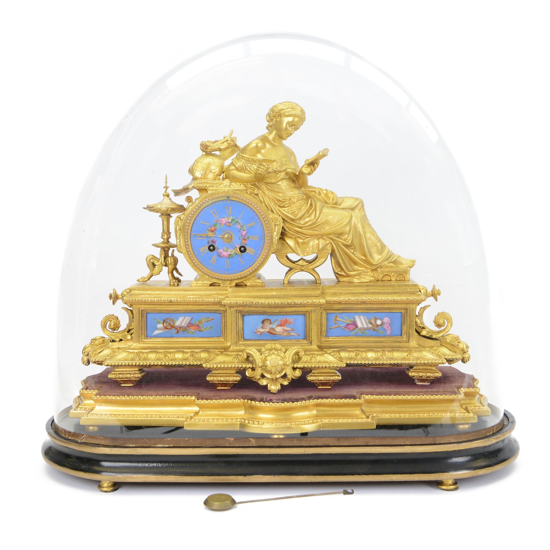 French- Napoleon III porcelain inset 8-day figural clock in a gilt case c1870, drum housed movement resting on a rectangular plinth with light blue porcelain panels each painted with different classical images and depictions from antiquity, conforming dial with a garland of flowers to the centre, gilt Roman numerals, minute track and brass spade hands, with a seated figure of a classical maiden reading a book, mounted on a matching gesso base with a velvet padded top, Parisian countwheel striking twin train movement, striking the hours and half hours on a bell. With a contemporary ebonised base and oval glass dome. With pendulum.
