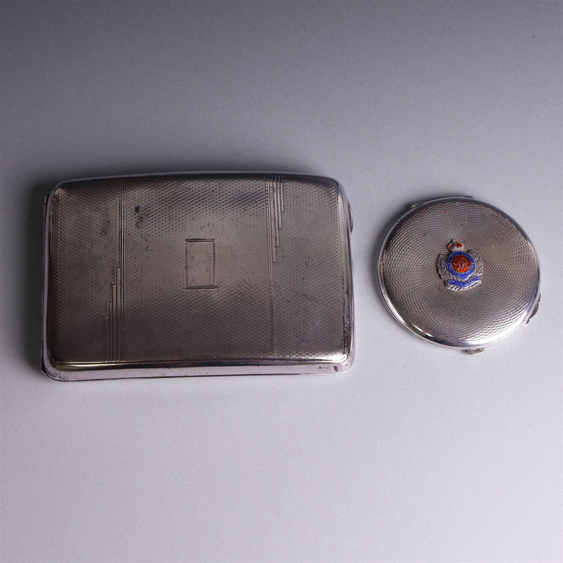 1930s silver cigarette case, of curved rectangular form with engine turned decoration and vacant cartouche, hallmarked Joseph Gloster Ltd, Birmingham 1934 and a 1930s silver sweetheart compact with engine turned decoration and enamel Royal Engineers crest, hallmarked Crisford & Norris Ltd, Birmingham 1939, cigarette box L12cm, H8cm