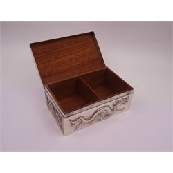 Late 19th century/early 20th century Chinese export silver mounted cigarette box, of rectangular form, decorated in relief with dragons, the hinged cover with similar dragon decoration and central blank oval cartouche, opening to reveal a softwood lined compartmentalised interior, stamped beneath with character mark and KMS for maker Kwong Man Shing, H6.3cm, W15.5cm, D9.5cm